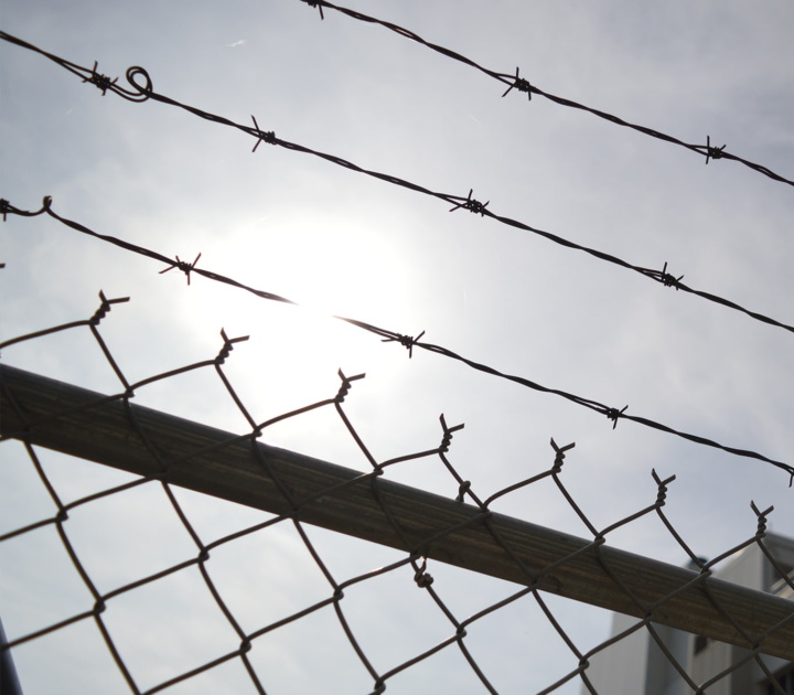 Barbed wire fencing outside a jail.