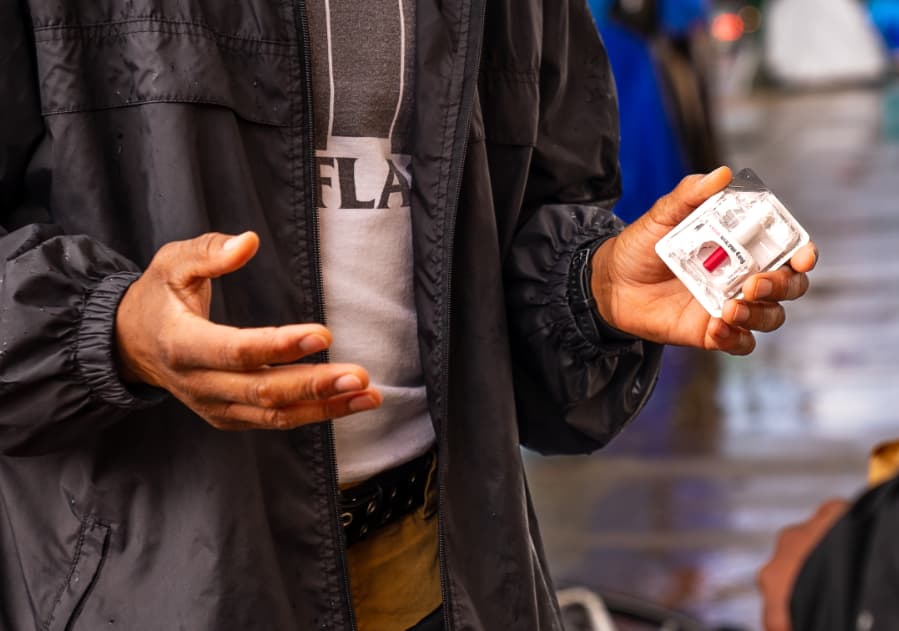 Closeup photo of someone holding naloxone.